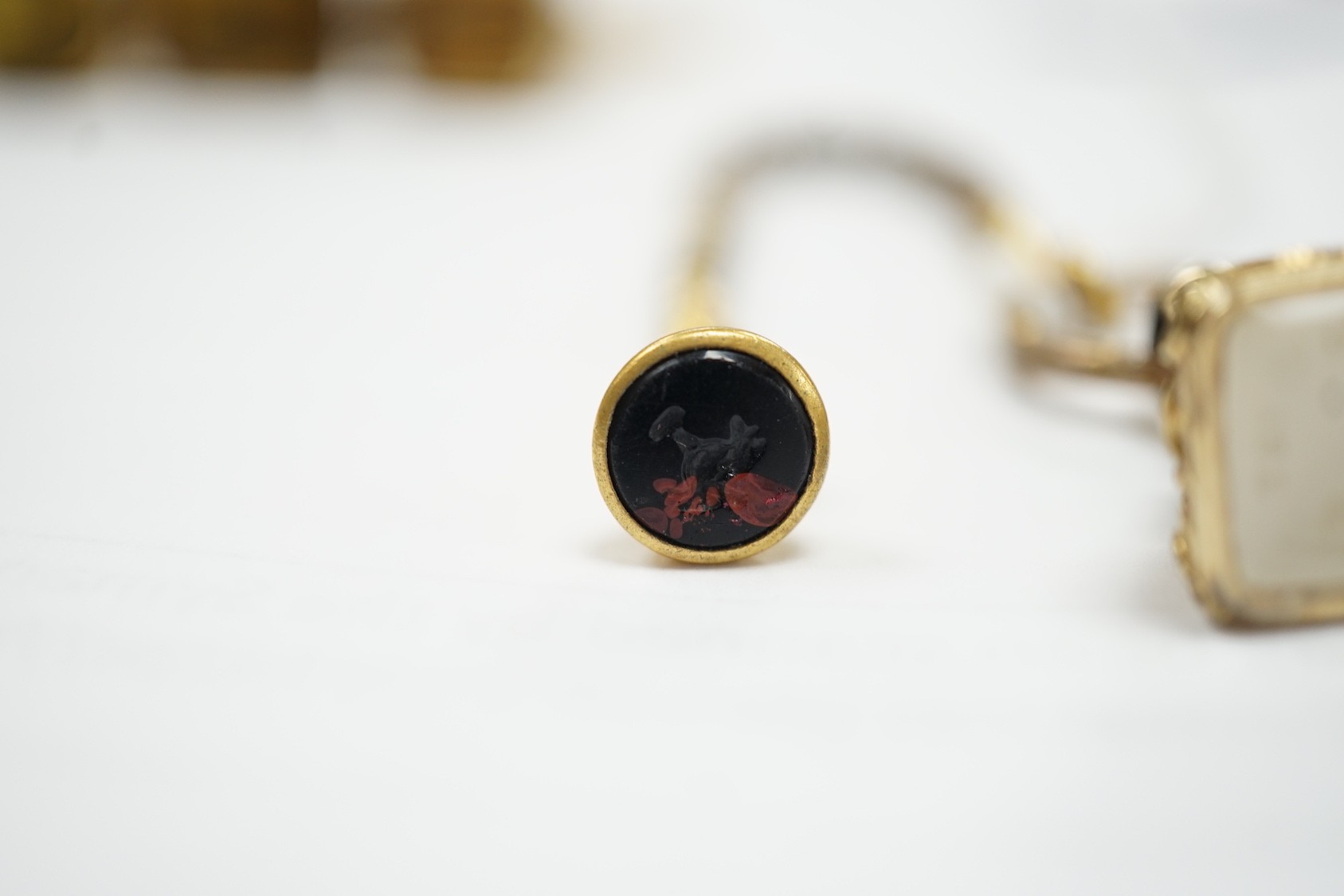 Four assorted 19th century gold plated fob seals, set with citrine, glass or carnelian, largest 30mm.